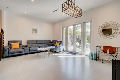 a living room with a couch and a table at Lux Villa Sol in Miami