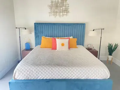 a bedroom with a large bed with colorful pillows at Lux Villa Sol in Miami