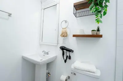 a bathroom with a sink and a toilet and a mirror at Family Home Casa Del Rio - Unit A in Miami
