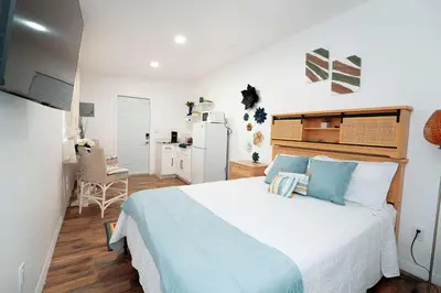 a bedroom with a large white bed with blue pillows at Rio retreat - Unit B in Miami