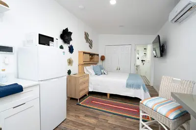 a kitchen and a bedroom with a bed and a refrigerator at Rio retreat - Unit B in Miami