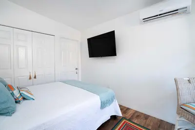 a bedroom with a bed and a tv on the wall at Rio retreat - Unit B in Miami