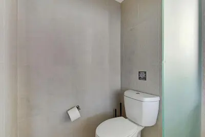 a bathroom with a toilet and a roll of toilet paper at Luxe Bayview Condo w Sauna, Hot tub & Beach Access in Fort Lauderdale