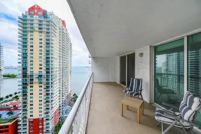 a balcony with two chairs and a view of the ocean at Luxury Bayview Condo | Pool, Gym & Skyline Views in Miami