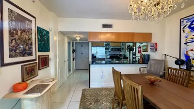 a kitchen and dining room with a table and a dining room at Urban Warmth Retreat in Miami