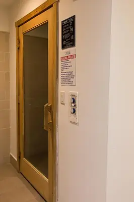 a elevator with a door and a sign on a wall at Urban Warmth Retreat in Miami