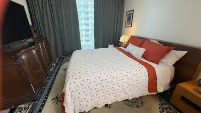 a bedroom with a large bed with red pillows at Urban Warmth Retreat in Miami