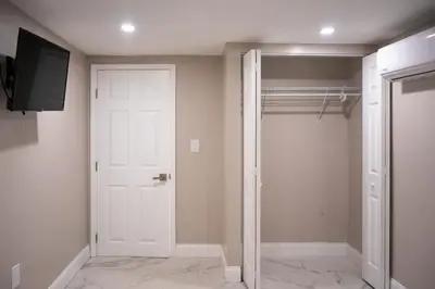 a walk in closet with a white door and a television at Peace and Tranquility awaits in Miami Gardens