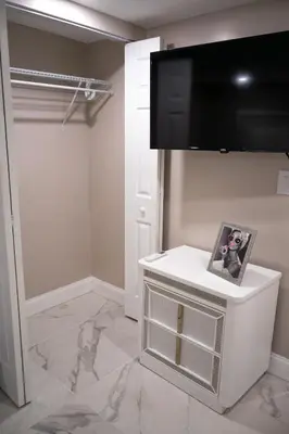 a room with a flat screen tv on a wall at Peace and Tranquility awaits in Miami Gardens