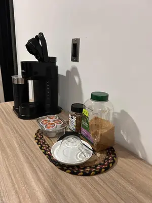 a table with a tray of food and a coffee maker at Cozy Home away from home! in Miami