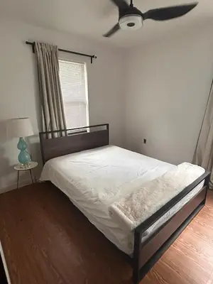 a bedroom with a bed and a ceiling fan at Cozy Home away from home! in Miami