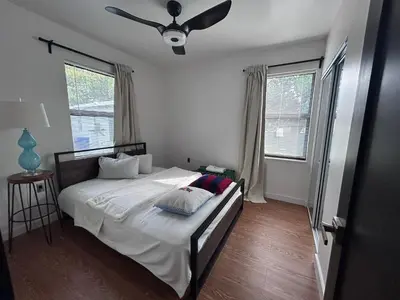 a bedroom with a bed with a ceiling fan at Cozy Home away from home! in Miami