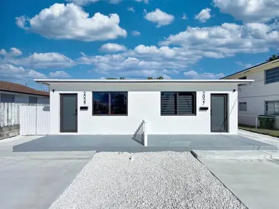 a white house with a parking lot at Miami Lux Retreat - Free Parking - Near Brickell in Miami
