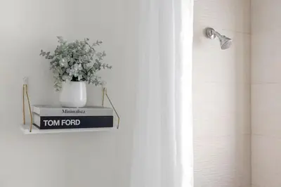 a bathroom with a tom pivot sign and a plant at Unit 1 Cozy 1BR Apt with Parking in Miami
