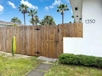 a wooden fence in front of a house at Unit 1 Cozy 1BR Apt with Parking in Miami