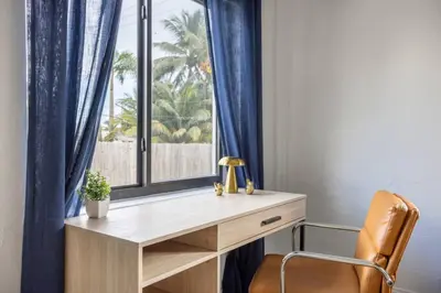 a wooden desk with a window and a chair at Unit 4 Beautiful 1BR Apt w Parking Near Biscayne Blvd in Miami