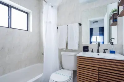 a bathroom with a tub and a toilet and a sink at Unit 4 Beautiful 1BR Apt w Parking Near Biscayne Blvd in Miami