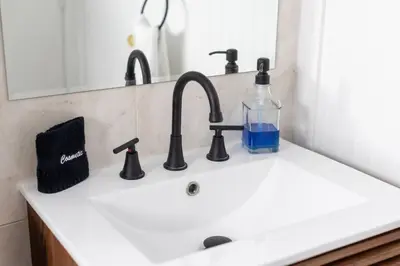 a sink with a bottle and a glass on it at Unit 4 Beautiful 1BR Apt w Parking Near Biscayne Blvd in Miami