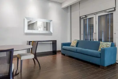 a living room with a blue couch and a table at Hollywood 1 BR Apt w Gym and Pool near the Beach in Hollywood