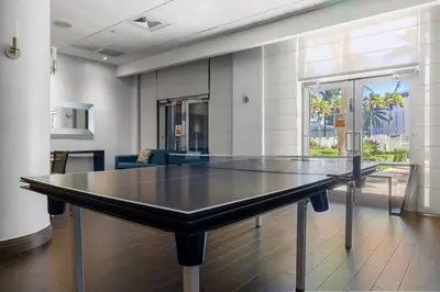 a ping pong table in the middle of a room at Hollywood 1 BR Apt w Gym and Pool near the Beach in Hollywood