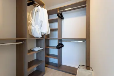 a walk in closet with wooden shelves and a sliding door at 72 Park Ocean view 1BR Apartment with Pool and Gym in Miami Beach