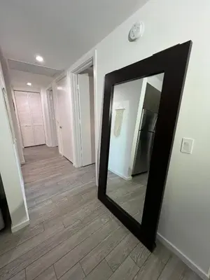 a mirror sitting on the floor in a hallway at Live Miami Vibes 2 Bedrooms Bayside Steps City Views Pool in Miami