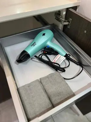 a blue phone sitting on top of a drawer at Live Miami Vibes 2 Bedrooms Bayside Steps City Views Pool in Miami
