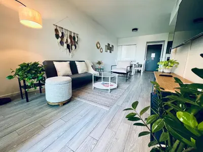 a living room with a couch and a table at Live Miami Vibes 2 Bedrooms Bayside Steps City Views Pool in Miami