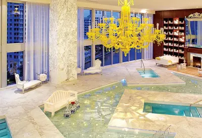a living room with a chandelier and a pool at Elegant 1B at Icon Brickell 17th fl Pool, Spa Gym FREE Parking Scenic view in Miami