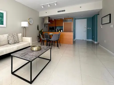 a living room with a couch and a table at Elegant 1B at Icon Brickell 17th fl Pool, Spa Gym FREE Parking Scenic view in Miami