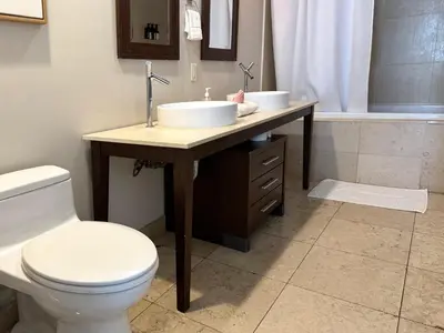 a bathroom with a sink and a toilet and a tub at Modern 1B at Icon Brickell 32nd fl Pool Spa Gym FREE Parking Scenic view in Miami