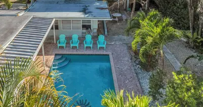 an overhead view of a swimming pool with blue chairs at Later Gator - Pool - Canal - Wilton Drive in Fort Lauderdale