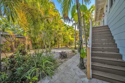 a staircase leading up to a house with palm trees at Later Gator - Pool - Canal - Wilton Drive in Fort Lauderdale