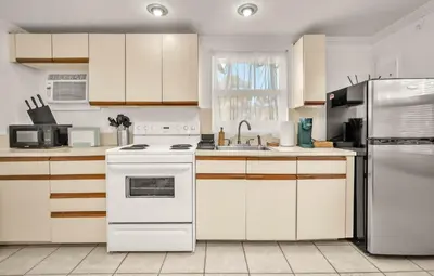 a kitchen with a white stove and a refrigerator at Later Gator - Pool - Canal - Wilton Drive in Fort Lauderdale