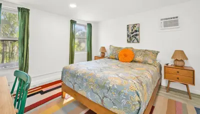 a bedroom with a bed with an orange pillow on it at Later Gator - Pool - Canal - Wilton Drive in Fort Lauderdale
