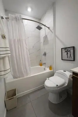 a bathroom with a toilet and a tub and a shower at Miami Skyline Residences by Untitled Stay in Miami