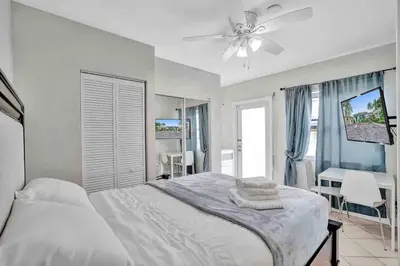 a bedroom with a bed and a ceiling fan at Cozy three bedroom near Hollywood beach in Hollywood