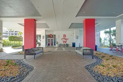 a lobby of a building with red pillars and benches at Ocean View 3 BDR Condo Pool Gym Private Balcony in Hallandale Beach