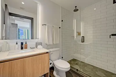a white bathroom with a toilet and a sink at Miami 30th floor 3BR Luxury Condo with Views in Miami