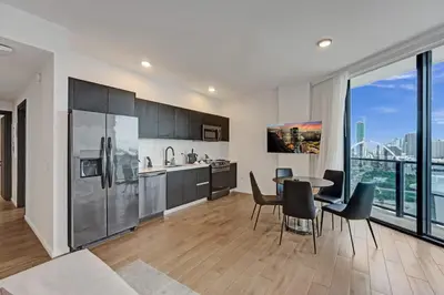 a kitchen and dining room with a table and chairs at Miami 30th floor 3BR Luxury Condo with Views in Miami