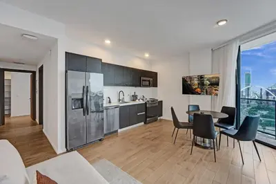 a kitchen and living room with a table and chairs at Miami 30th floor 3BR Luxury Condo with Views in Miami