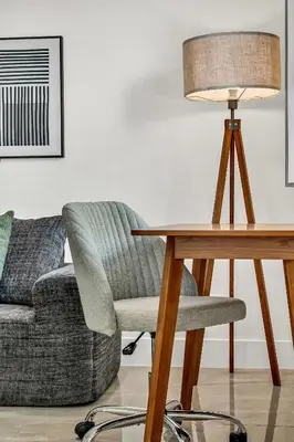 a desk with a chair and a lamp next to a couch at Bright 1BR Getaway Victoria Park Las Olas Nearby in Fort Lauderdale