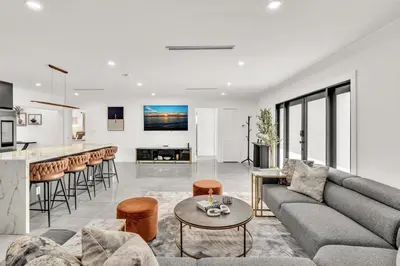 a living room with a couch and a table at Lux Villa Heated Pool, Gym, Games, Golf, Near Beach in Hollywood