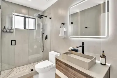 a bathroom with a sink and a toilet and a shower at Lux Villa Heated Pool, Gym, Games, Golf, Near Beach in Hollywood