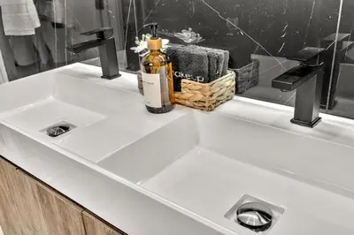 a bathroom sink with a bottle of soap on it at Lux Villa Heated Pool, Gym, Games, Golf, Near Beach in Hollywood