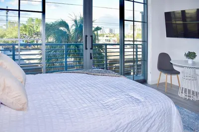 a bedroom with a large white bed and a table at The Juliet VIII Vibe 8706 in Miami