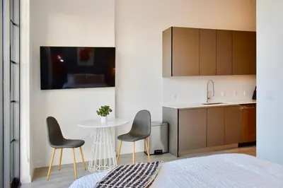 a room with a table and two chairs and a kitchen at The Juliet VIII Vibe 8706 in Miami