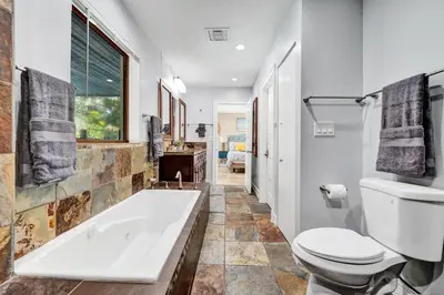 a bathroom with a tub and a toilet at The Porch House - 3 Bed 2 Bath Pool Home in Hollywood