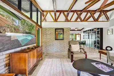 a living room with a tv and a table at The Porch House - 3 Bed 2 Bath Pool Home in Hollywood