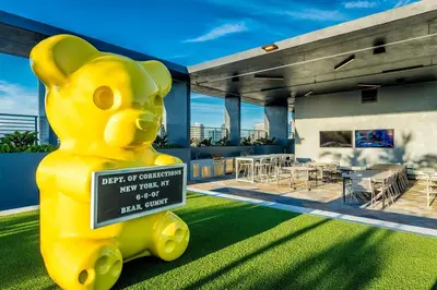 a large yellow teddy bear statue in front of a house at The Juliet XIV Vibe 8801 in Miami